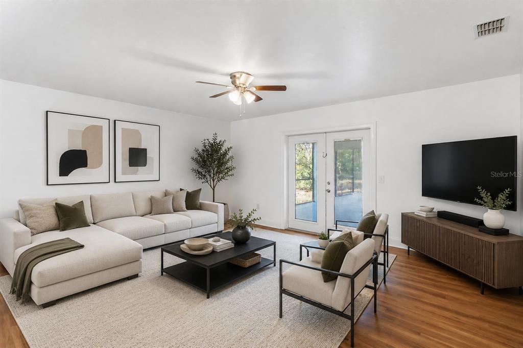 A living room features a sectional sofa, two armchairs, a coffee table, and a television — 7524 QUAIL RUN COURT, ORLANDO, FL