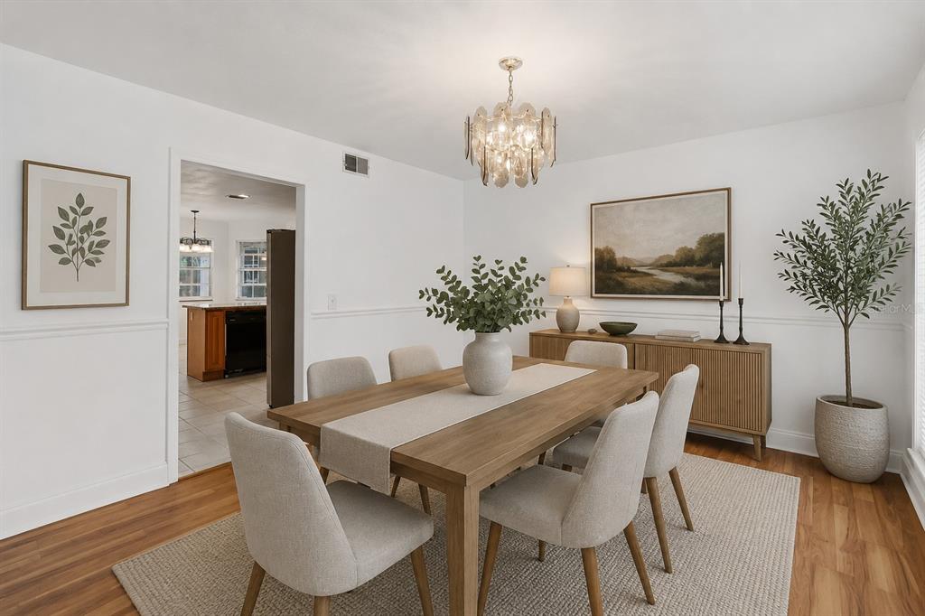 A dining room features a wooden table, six chairs, a sideboard, and a chandelier — 7524 QUAIL RUN COURT, ORLANDO, FL