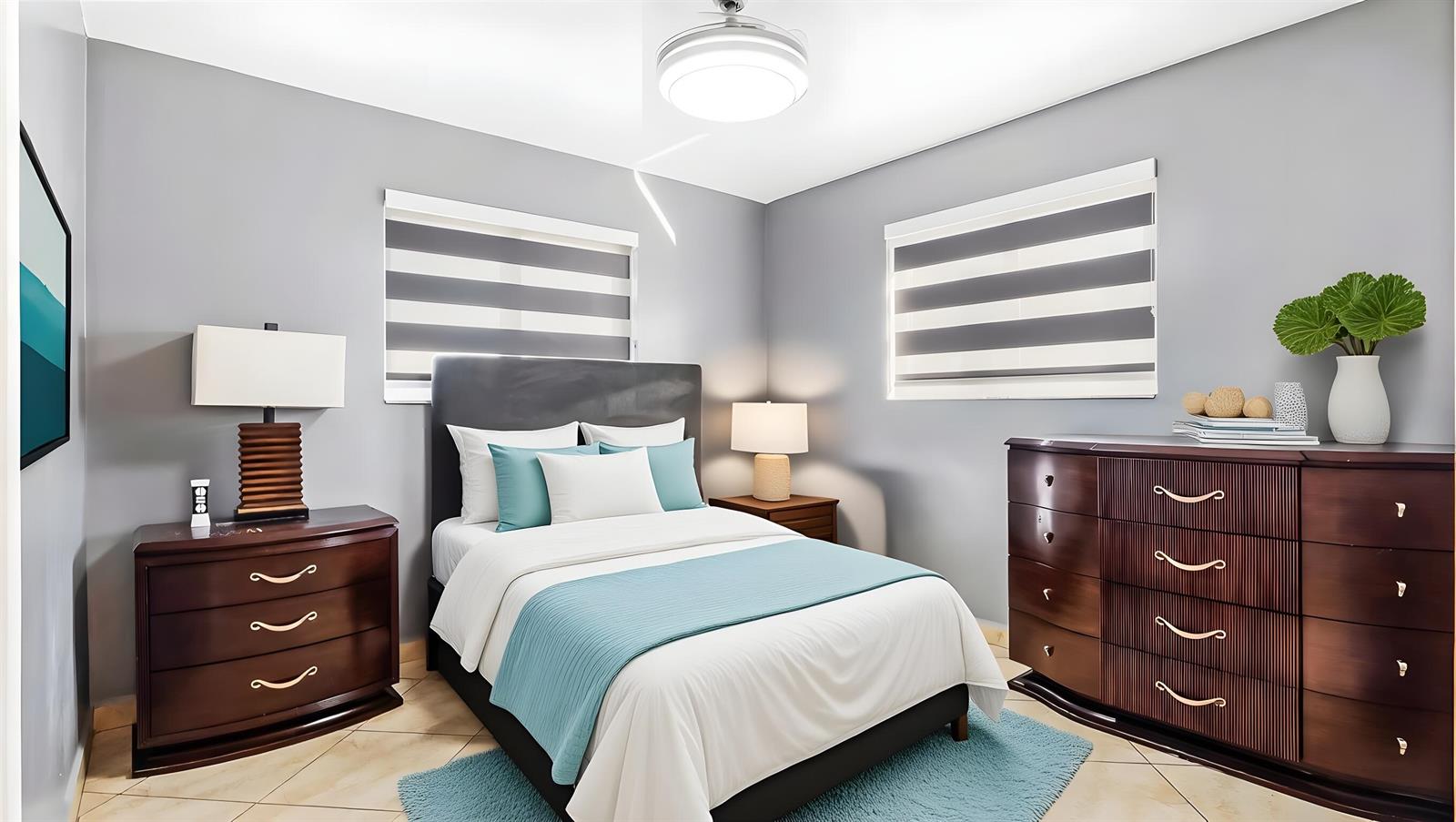 A bedroom with a bed, two dark wood dressers, and gray walls with striped blinds — 3140 Sheridan Lane, Hollywood FL 33021, HOLLYWOOD, FL