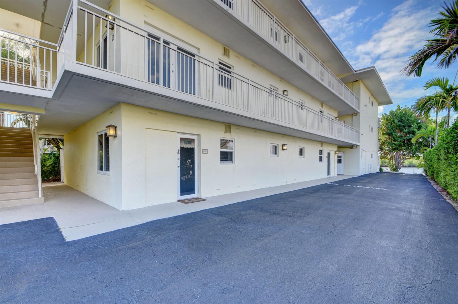 A low-angle exterior view of a multi-story apartment building with a parking lot — 6520 N Ocean Boulevard # 3, Ocean Ridge FL 33435, OCEAN RIDGE, FL