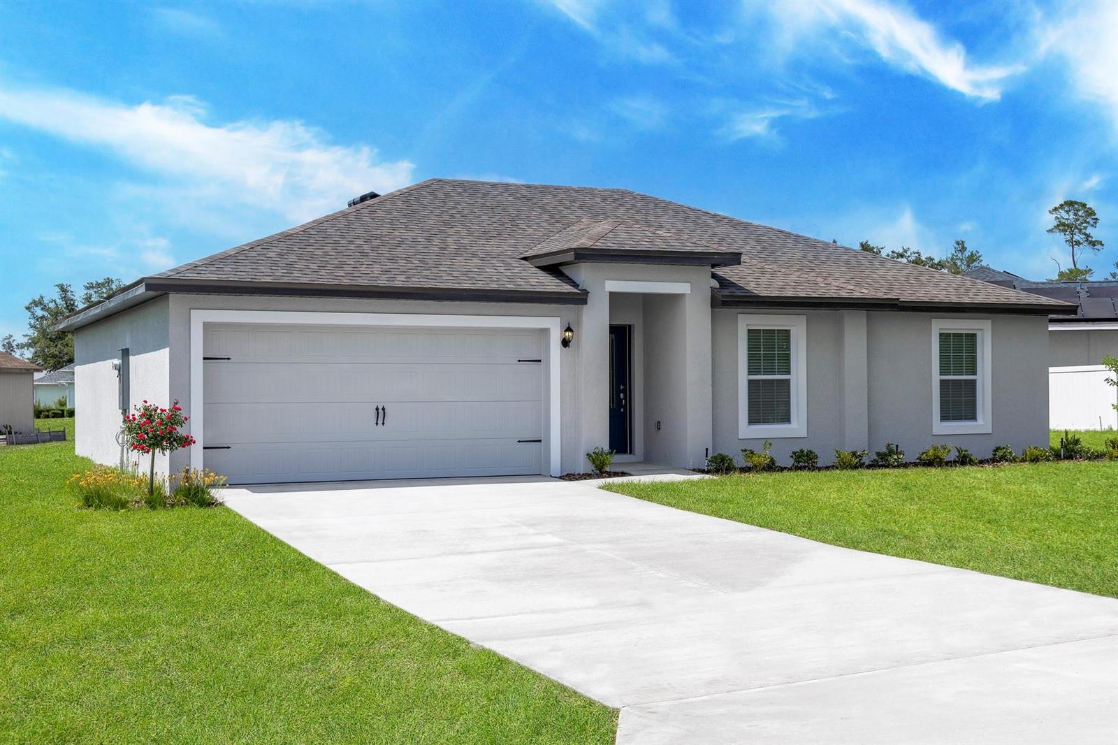 A single-story house with a gray stucco exterior, a two-car garage, and a concrete driveway — 8045 105th Court, Vero Beach FL 32967, VERO BEACH, FL