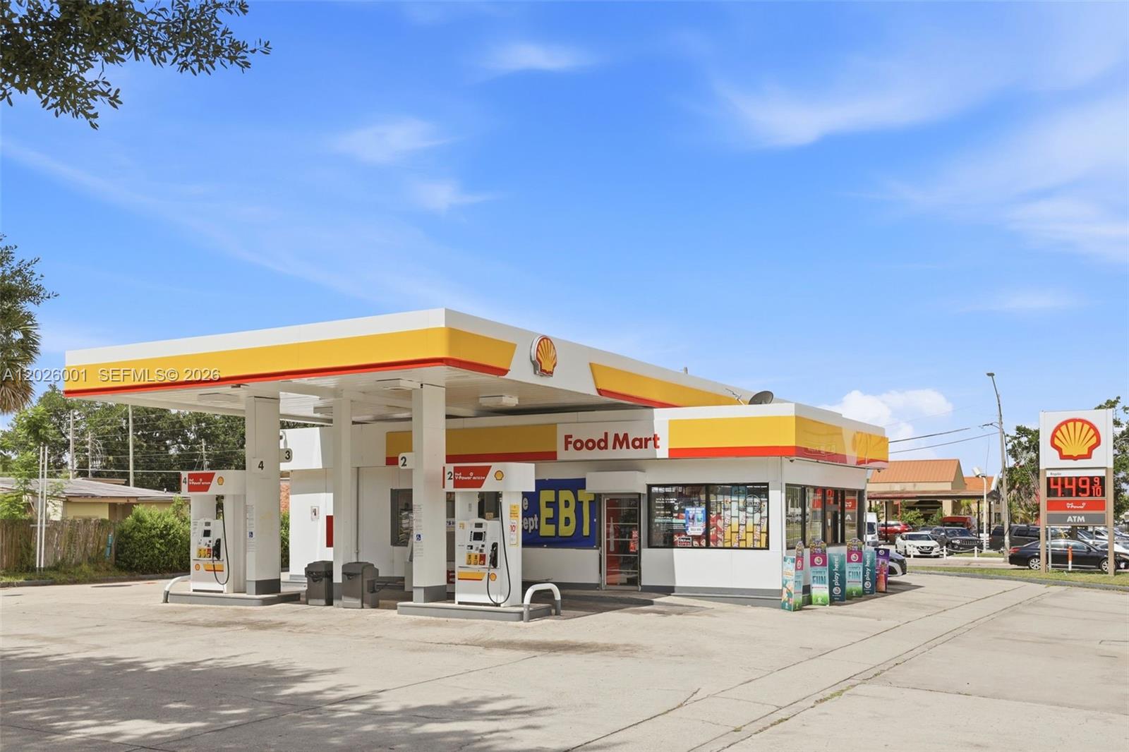 A Shell gas station with a food mart and fuel pumps under a canopy — 1916 W COLONIAL DR, Orlando FL 32804, ORLANDO, FL