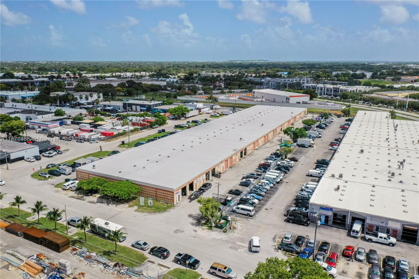 An aerial view shows two long commercial warehouse buildings with parking lots and surrounding industrial properties — 18625 SW 105 AV, Miami FL 33157, MIAMI, FL