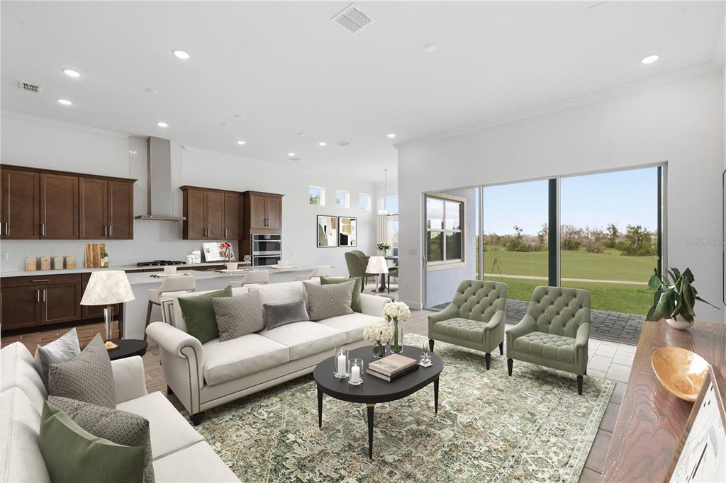 An open-concept living room and kitchen with dark wood cabinets and a view of golf — 1031 SIGNET, APOLLO BEACH, FL