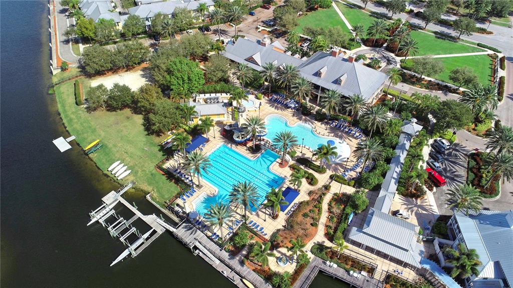 An aerial view of a community clubhouse featuring a swimming pool, lap pool, and dock — 1031 SIGNET, APOLLO BEACH, FL