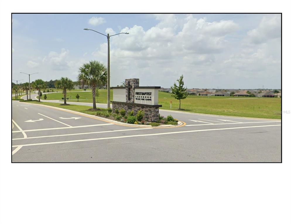 A stone monument sign for First Baptist Leesburg stands at a road intersection — CR 466A / MILLER BOULEVARD UNIT #B & #C, FRUITLAND PARK, FL