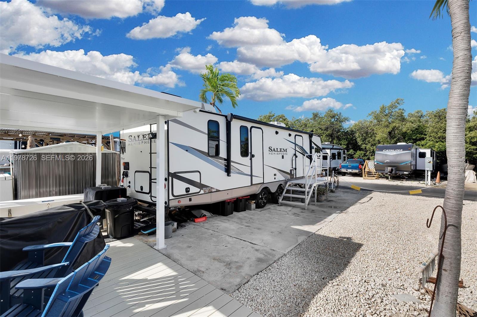 A white Salem Hemisphere travel trailer is parked on a concrete pad under a canopy — 6099 Overseas Hwy 55W, Marathon FL 33050, MARATHON, FL