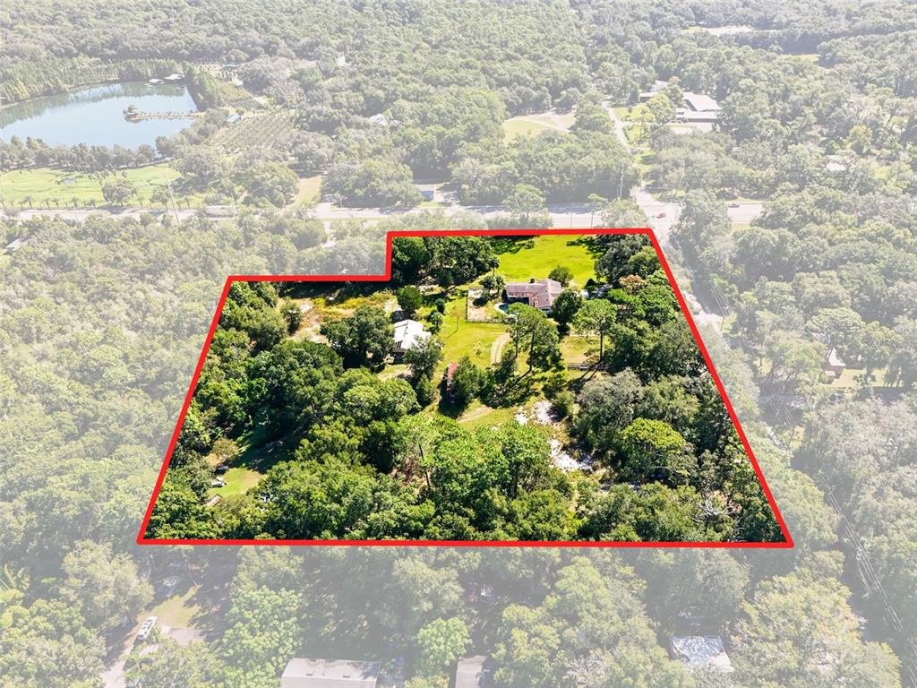 An aerial view shows a large, wooded residential property outlined in red — 51 E PONKAN ROAD, APOPKA, FL