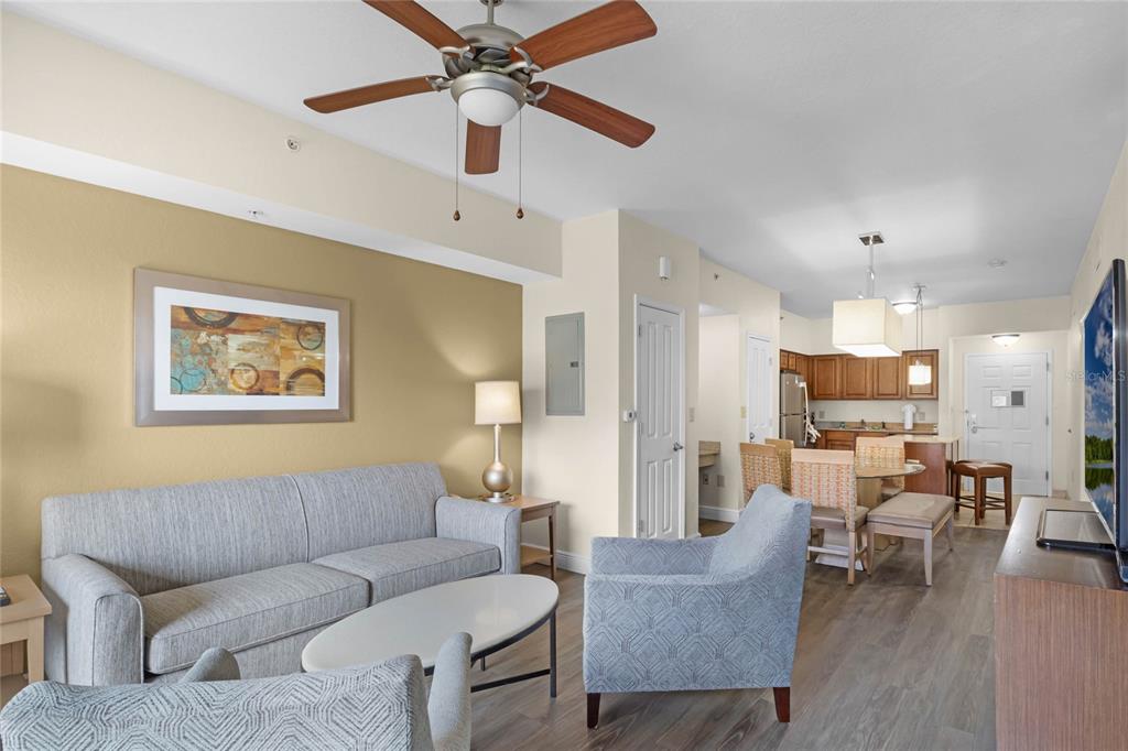 A living room with a sofa, armchairs, and an open kitchen with a dining area — 12544 FLORIDAYS RESORT DRIVE UNIT 106B, ORLANDO, FL