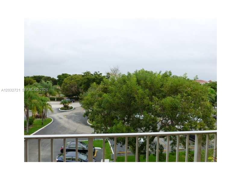 An elevated view overlooks a parking lot, green trees, and a cloudy sky — 13100 SW 92nd Ave, Miami FL 33176, MIAMI, FL
