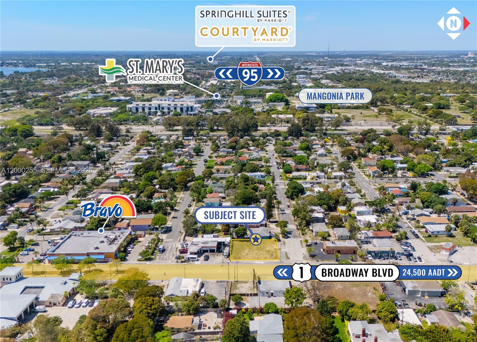 This aerial view shows a vacant lot for sale along a busy commercial street — 5179 Broadway, West Palm Beach FL 33407, WEST PALM BEACH, FL