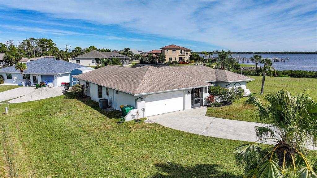 An aerial view shows a single-story house with a tan roof and white exterior walls — 3522 FOX TERRACE, PORT CHARLOTTE, FL