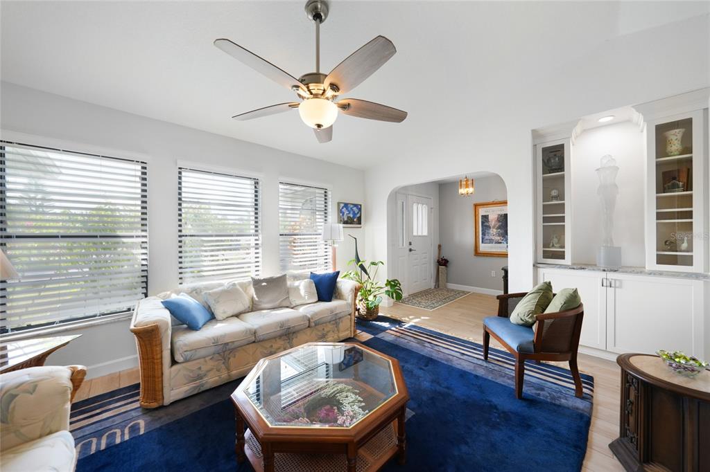 A living room features a blue area rug, a floral sofa, and a ceiling fan — 3522 FOX TERRACE, PORT CHARLOTTE, FL