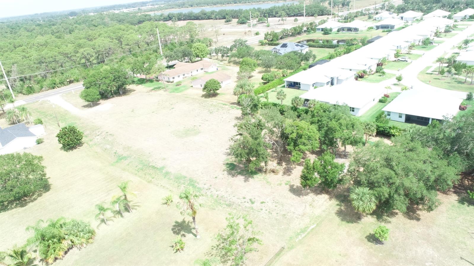 An aerial view shows a large grassy lot adjacent to a residential neighborhood — 4720 58th Ave Avenue, Vero Beach FL 32967, VERO BEACH, FL