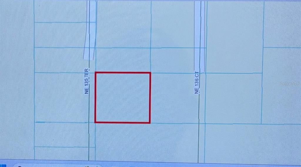 This is a map showing a rectangular parcel of land highlighted in red — 0 NE 135TH TERRACE, FORT MC COY, FL