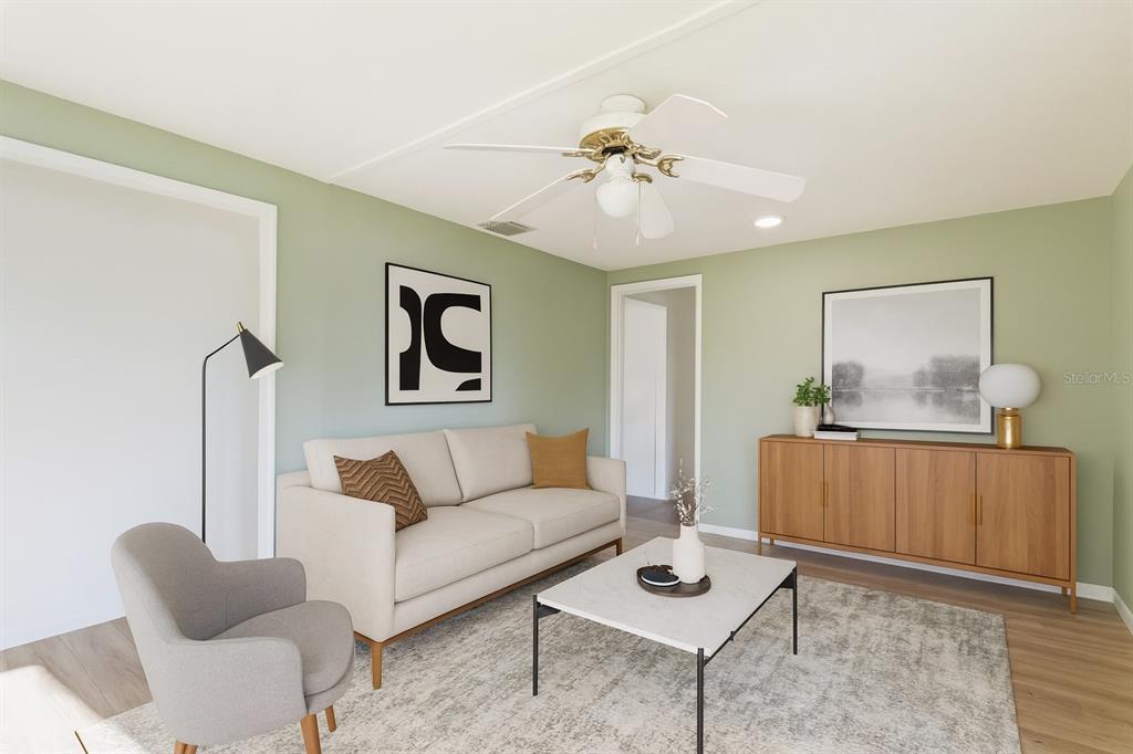 This is a digital rendering of a living room with light green walls and modern furniture — 1255 S MARYKNOLL ROAD, ENGLEWOOD, FL