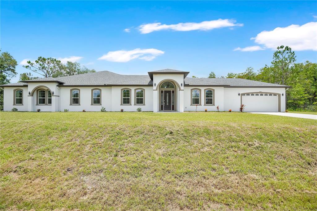 A single-story white house with a gray roof and a three-car garage — 3307 DALLAS BOULEVARD, ORLANDO, FL
