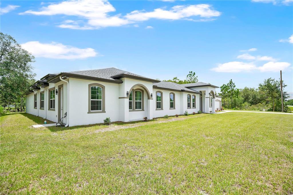 A white, single-story house with a gray hip roof sits on a grassy lot — 3307 DALLAS BOULEVARD, ORLANDO, FL