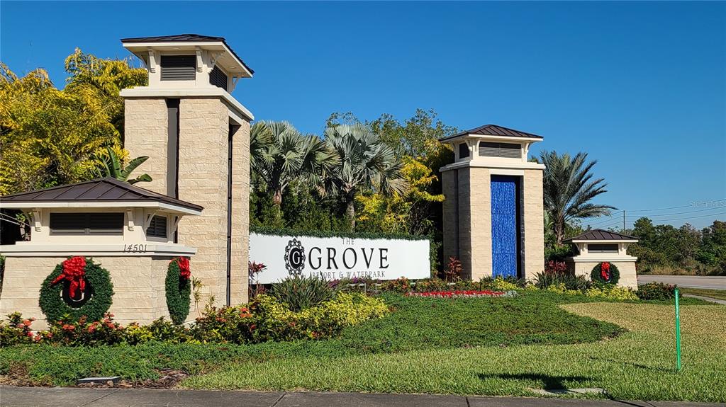 The entrance to The Grove Resort & Waterpark features stone pillars and landscaping — 14501 GROVE RESORT AVENUE UNIT 1603, WINTER GARDEN, FL