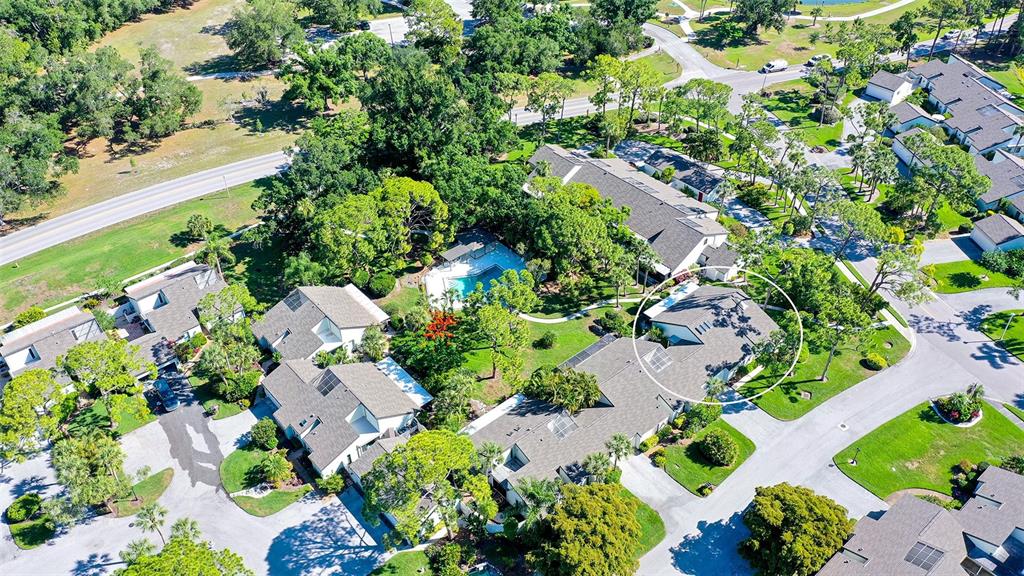 An aerial view shows a residential complex with multiple buildings, a pool, and surrounding landscaping — 4391 WOODMANS CHART UNIT 155, SARASOTA, FL