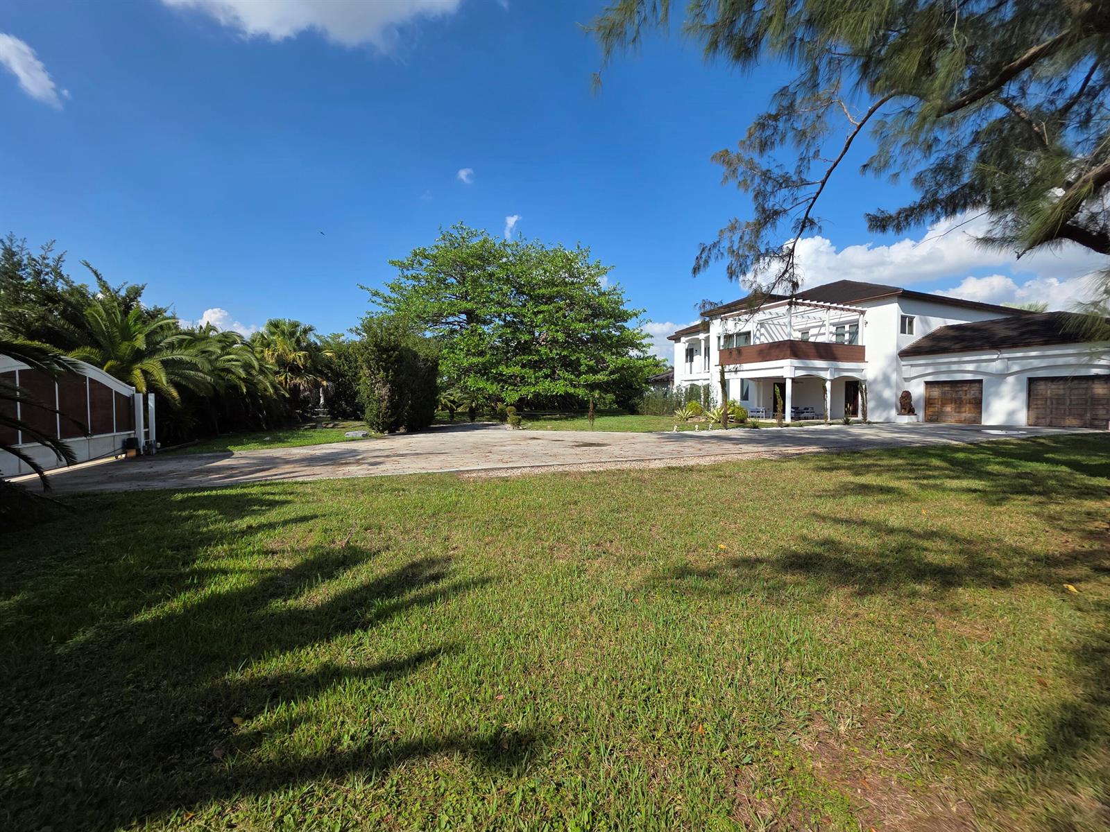 A large white two-story house with a paved driveway and a spacious green lawn — 4501 SW 143rd Avenue, Miramar FL 33027, MIRAMAR, FL