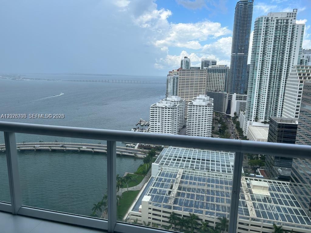A high-rise balcony overlooks a bay, a bridge, and the Miami skyline — 495 Brickell Ave # 3203, Miami FL 33131, MIAMI, FL