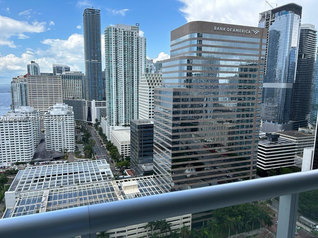 An elevated view of a dense city skyline featuring the Bank of America tower — 495 Brickell Ave # 3203, Miami FL 33131, MIAMI, FL