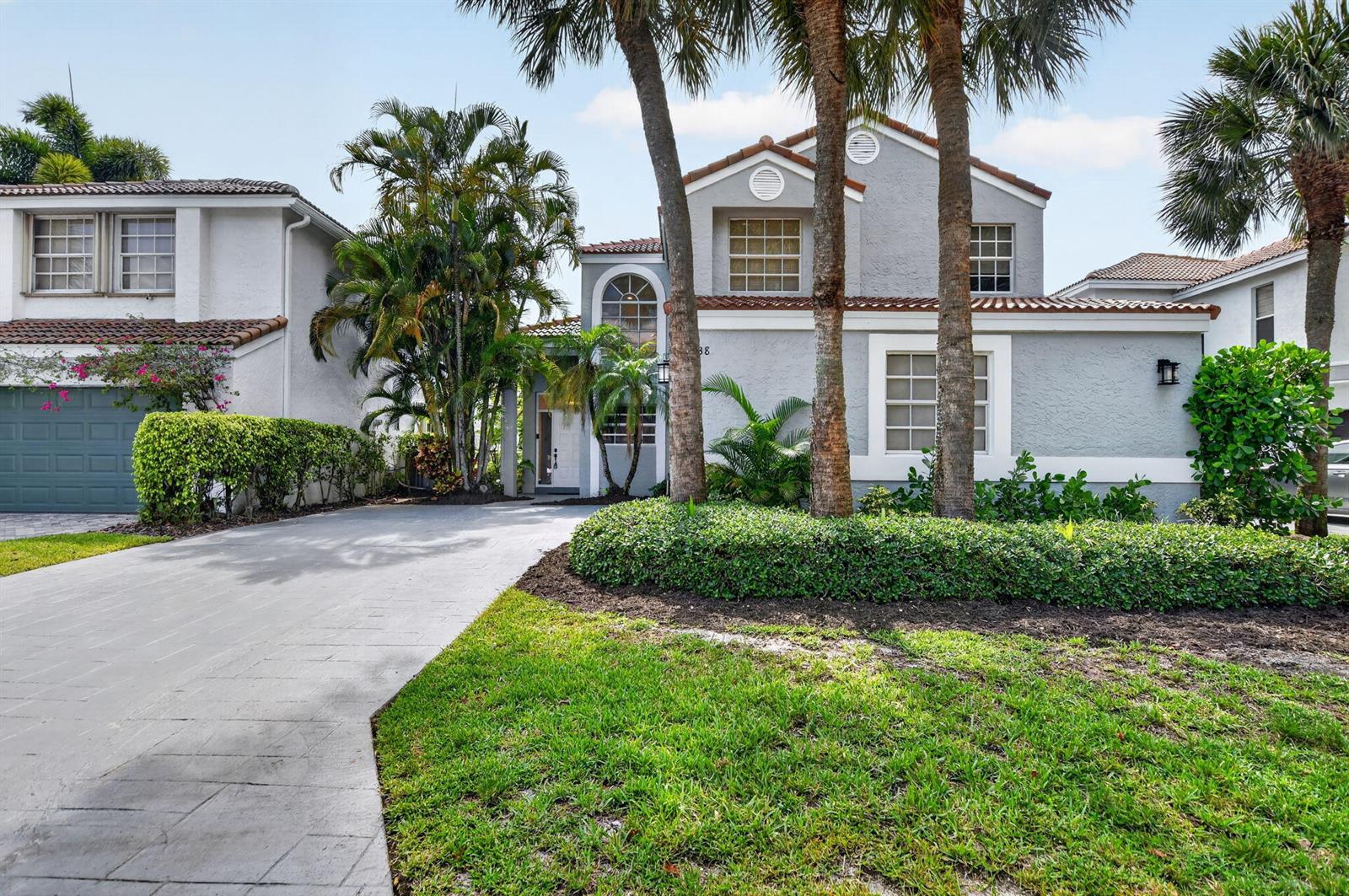 A two-story gray house with a paved driveway, palm trees, and manicured landscaping — 23338 La Vida Way, Boca Raton FL 33433, BOCA RATON, FL