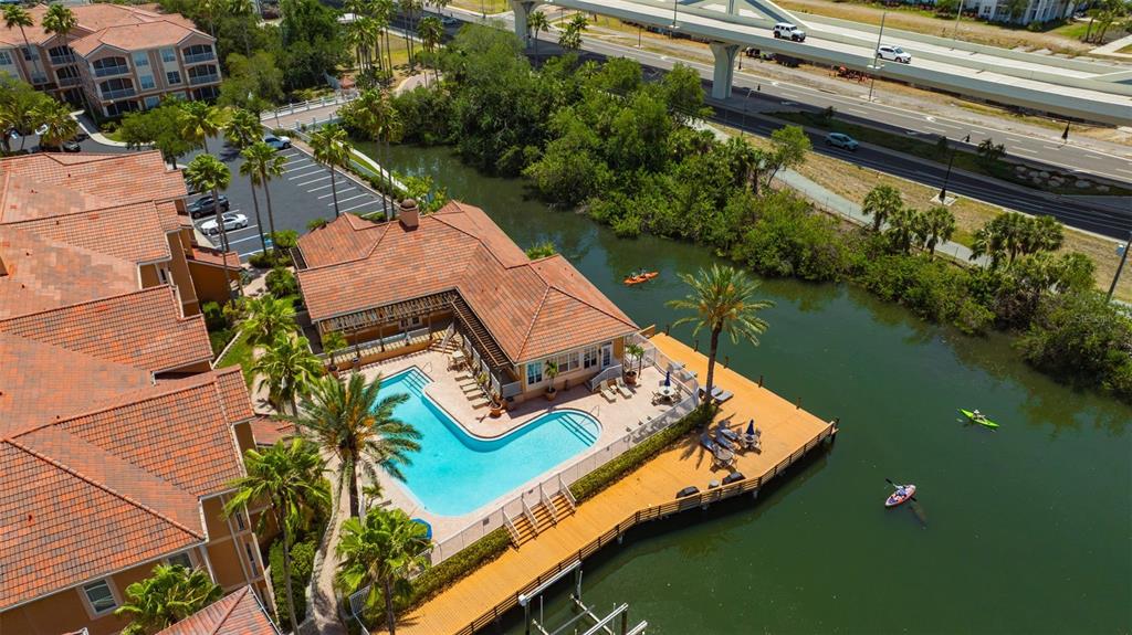An aerial view shows a residential building with a swimming pool and a wooden deck — 5000 CULBREATH KEY WAY UNIT 1-306, TAMPA, FL