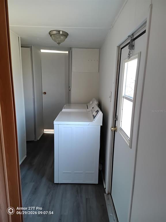 A laundry room features white appliances, gray wood-look flooring, and a door with a window — 5031 4TH STREET E, BRADENTON, FL
