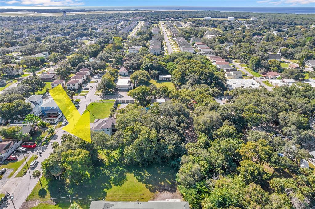 An aerial view shows a residential neighborhood with a yellow arrow pointing toward a house — 7111 S KISSIMMEE STREET, TAMPA, FL