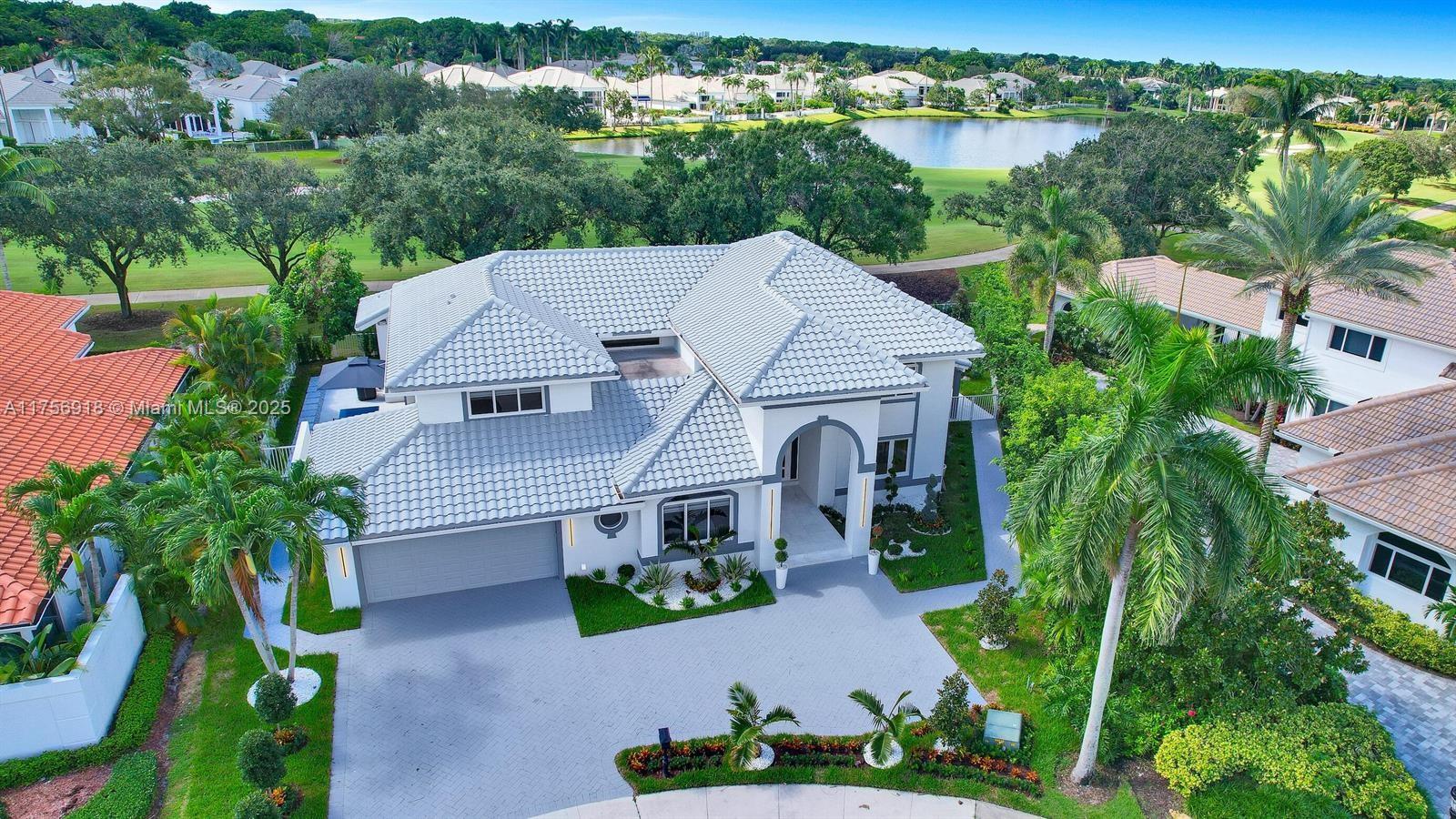 An aerial view shows a two-story house with a gray tile roof and paved driveway — 2578 NW 63rd Ln, Boca Raton FL 33496, BOCA RATON, FL