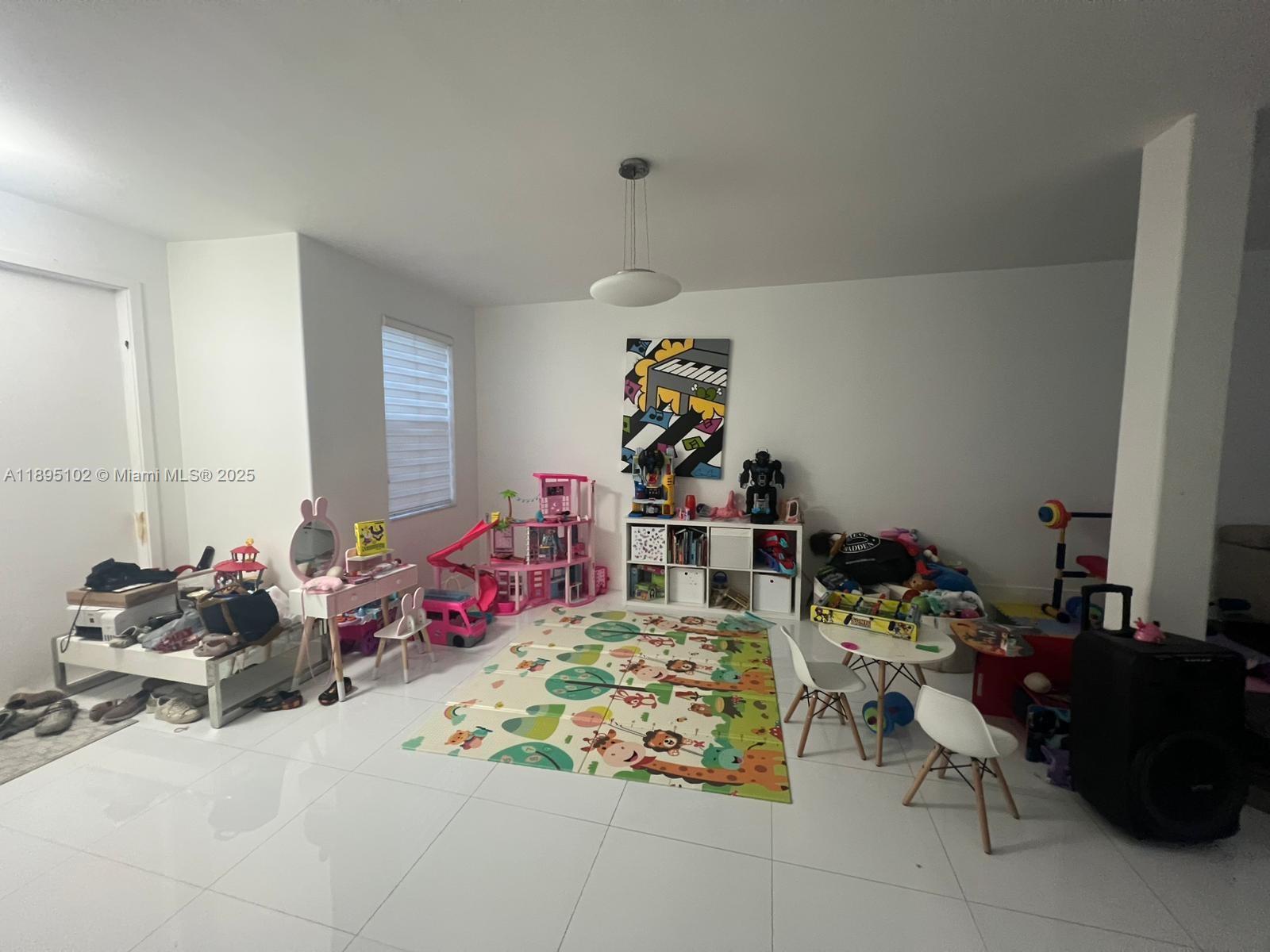 A brightly lit children's playroom features white tile floors, a play mat, and various toys — 11281 NW 84th St, Doral FL 33178, DORAL, FL