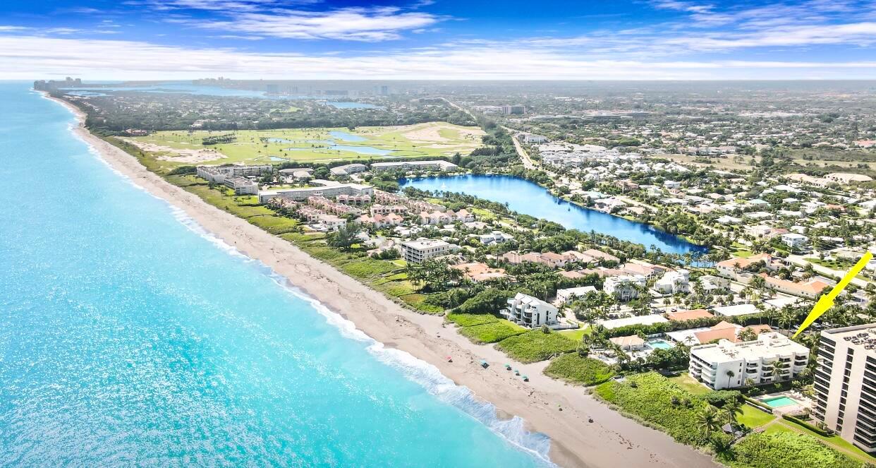 An aerial view of a coastal residential area with a beach and a large lake — 420 Celestial Way # 301, Juno Beach FL 33408, JUNO BEACH, FL