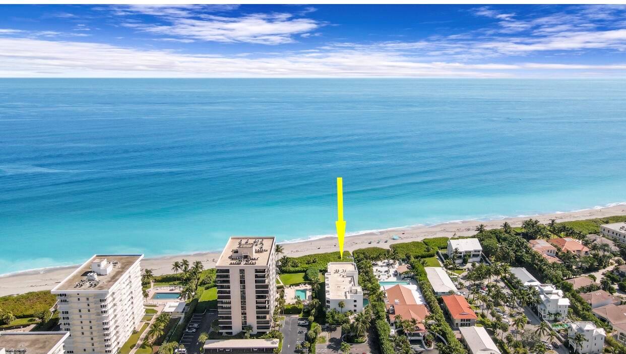 An aerial view shows a beachfront condominium building marked by a yellow arrow — 420 Celestial Way # 301, Juno Beach FL 33408, JUNO BEACH, FL
