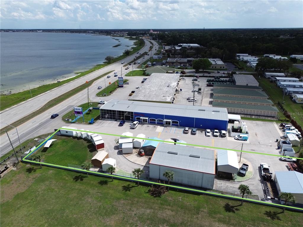 An aerial view shows a commercial property with multiple buildings, storage units, and a parking lot — 177 US HIGHWAY 27 S, SEBRING, FL