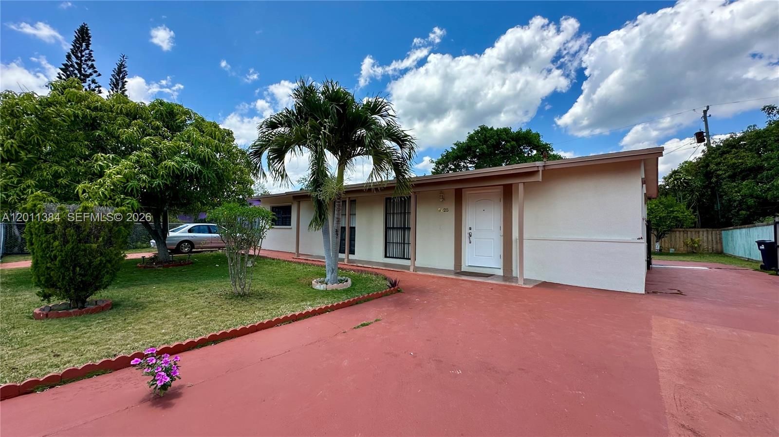 A single-story house with a white exterior, a red driveway, and a palm tree — 9625 SW 164th St, Miami FL 33157, MIAMI, FL