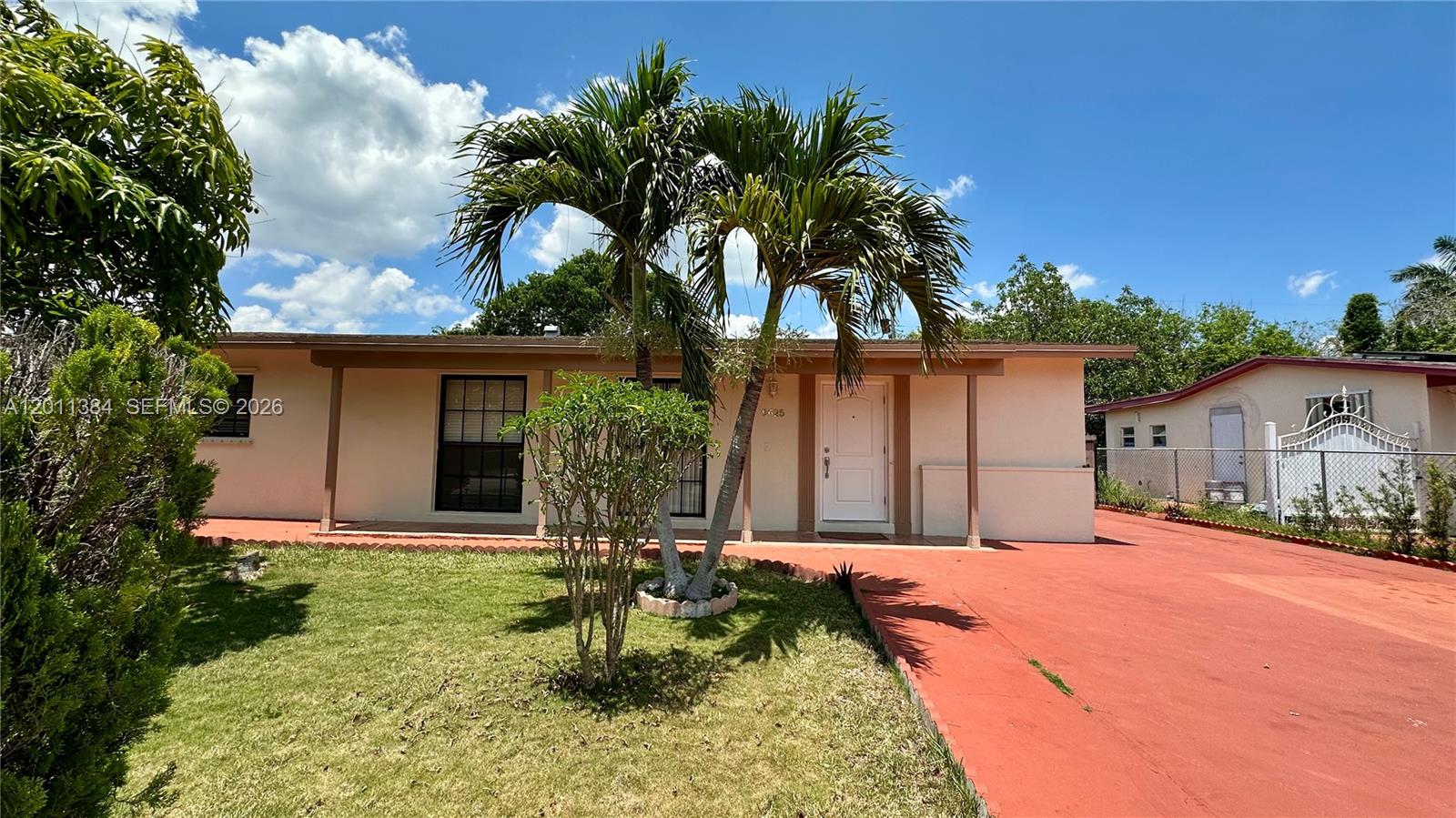 A single-story house with a red driveway, a front porch, and a palm tree — 9625 SW 164th St, Miami FL 33157, MIAMI, FL