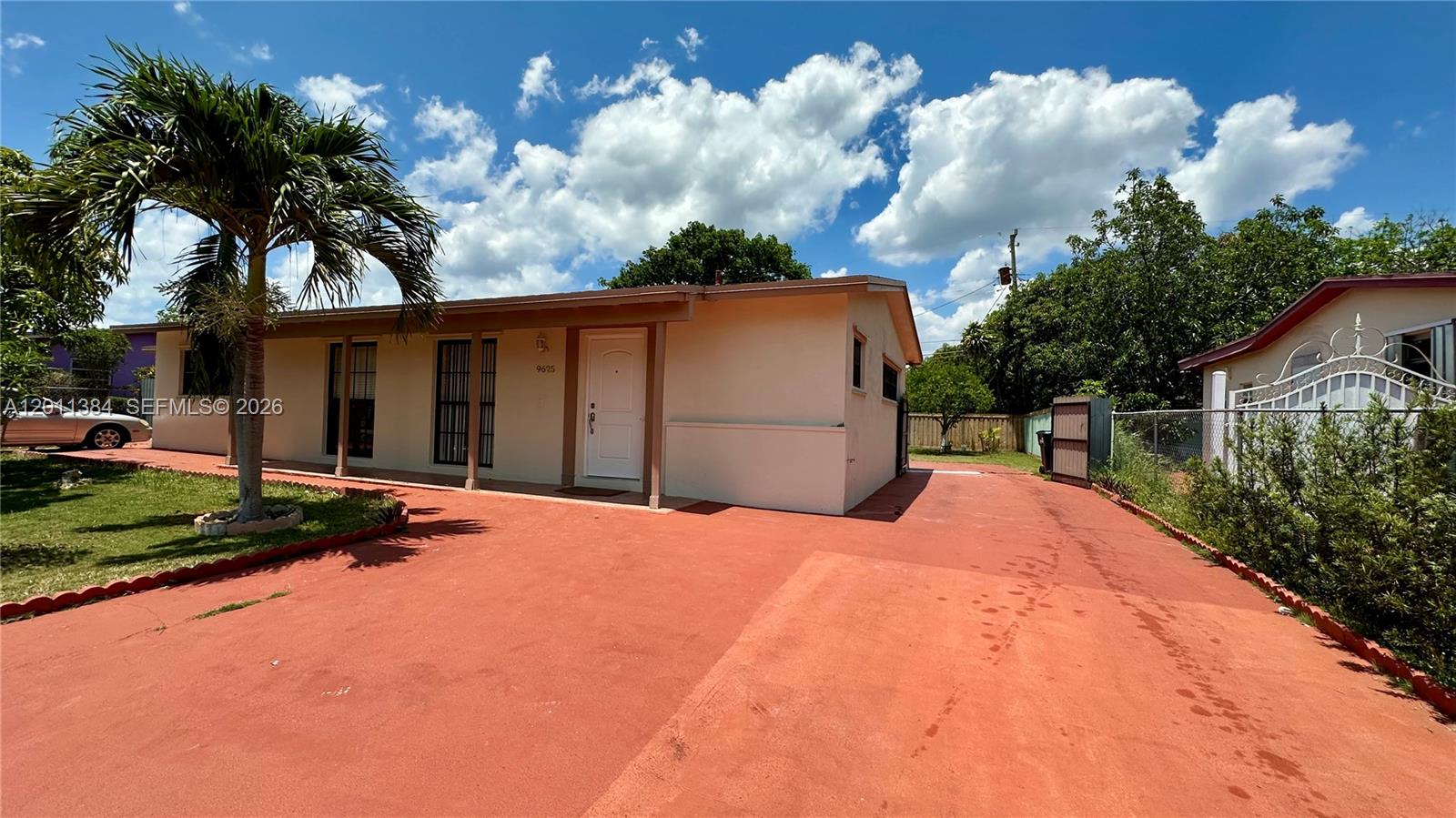 A single-story house with a red concrete driveway and a palm tree in the yard — 9625 SW 164th St, Miami FL 33157, MIAMI, FL