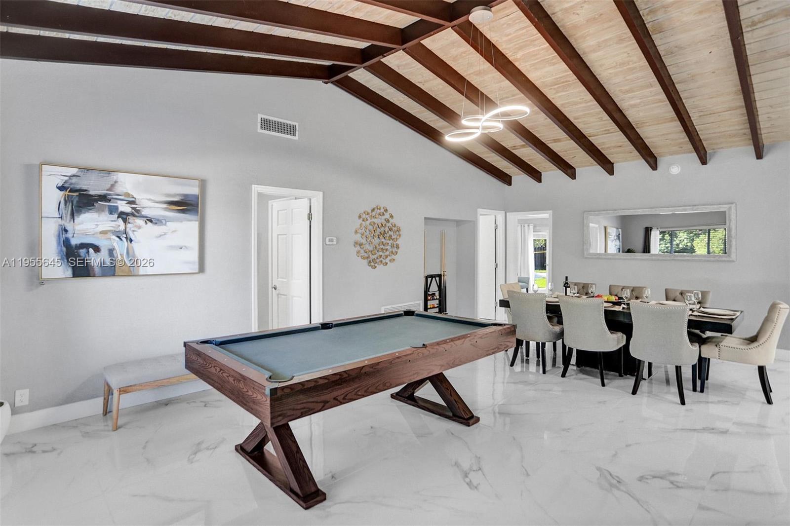 A dining room and game area feature a pool table, vaulted ceiling, and marble flooring — 2797 NE 21st Ter, Lighthouse Point FL 33064, LIGHTHOUSE POINT, FL