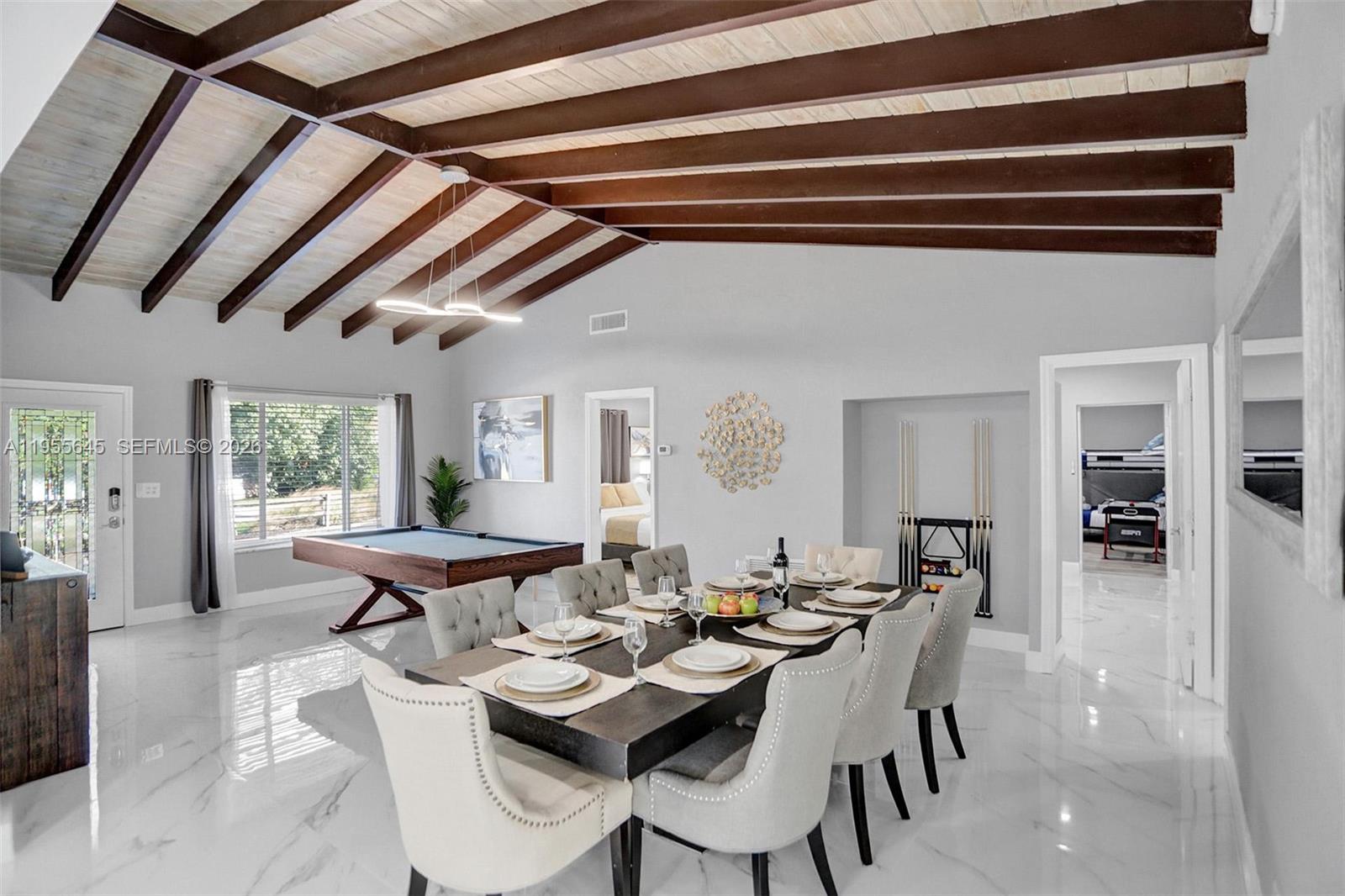 A dining room with a pool table features vaulted wood-beamed ceilings and marble floors — 2797 NE 21st Ter, Lighthouse Point FL 33064, LIGHTHOUSE POINT, FL