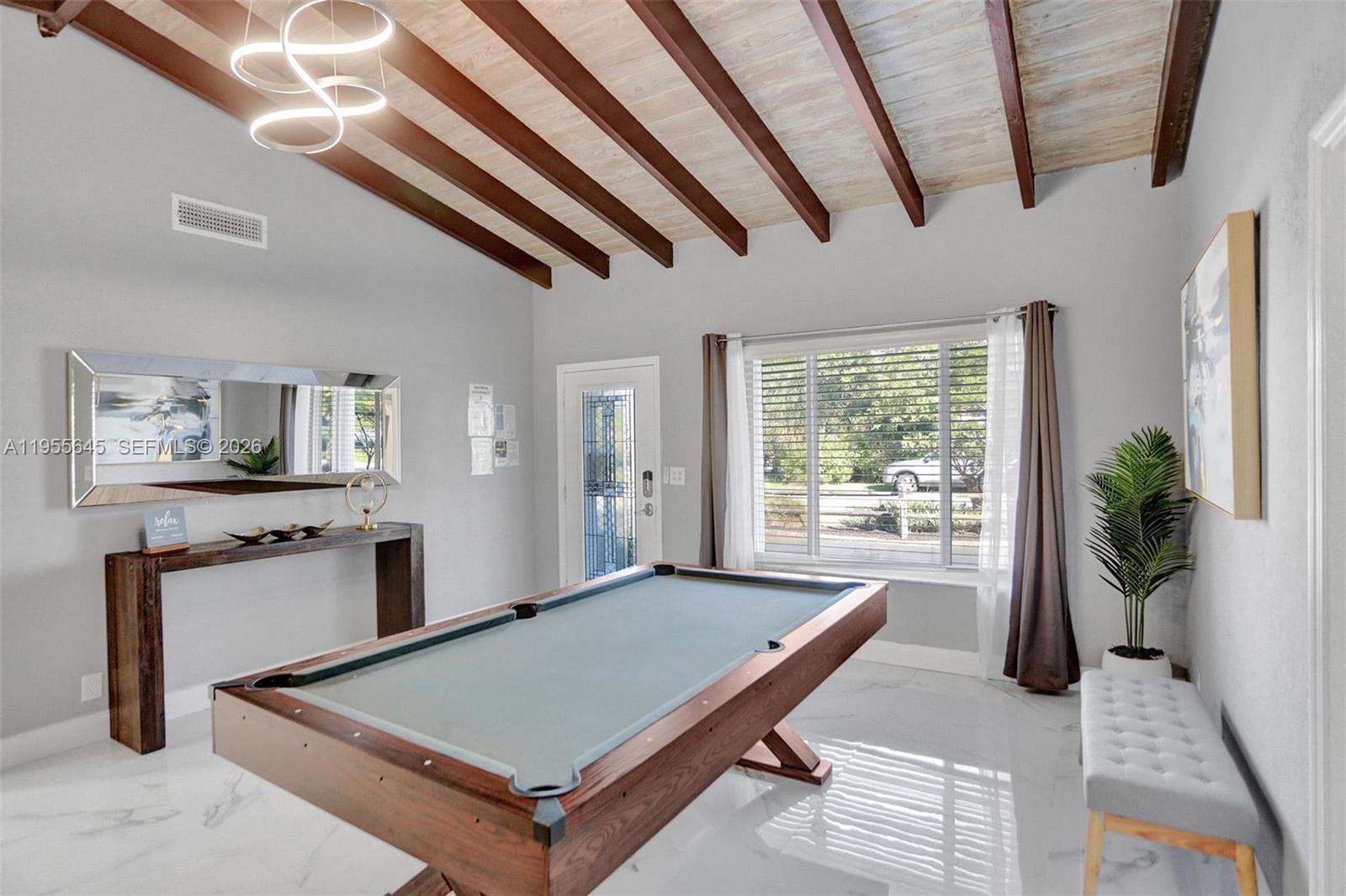 A room with a pool table, vaulted wood-beam ceiling, and white tile flooring — 2797 NE 21st Ter, Lighthouse Point FL 33064, LIGHTHOUSE POINT, FL