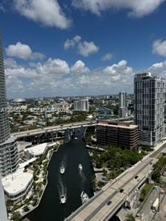 An elevated view of a city waterway with boats, bridges, and surrounding high-rise buildings — 185 SW 7th St # 3009, Miami FL 33130, MIAMI, FL