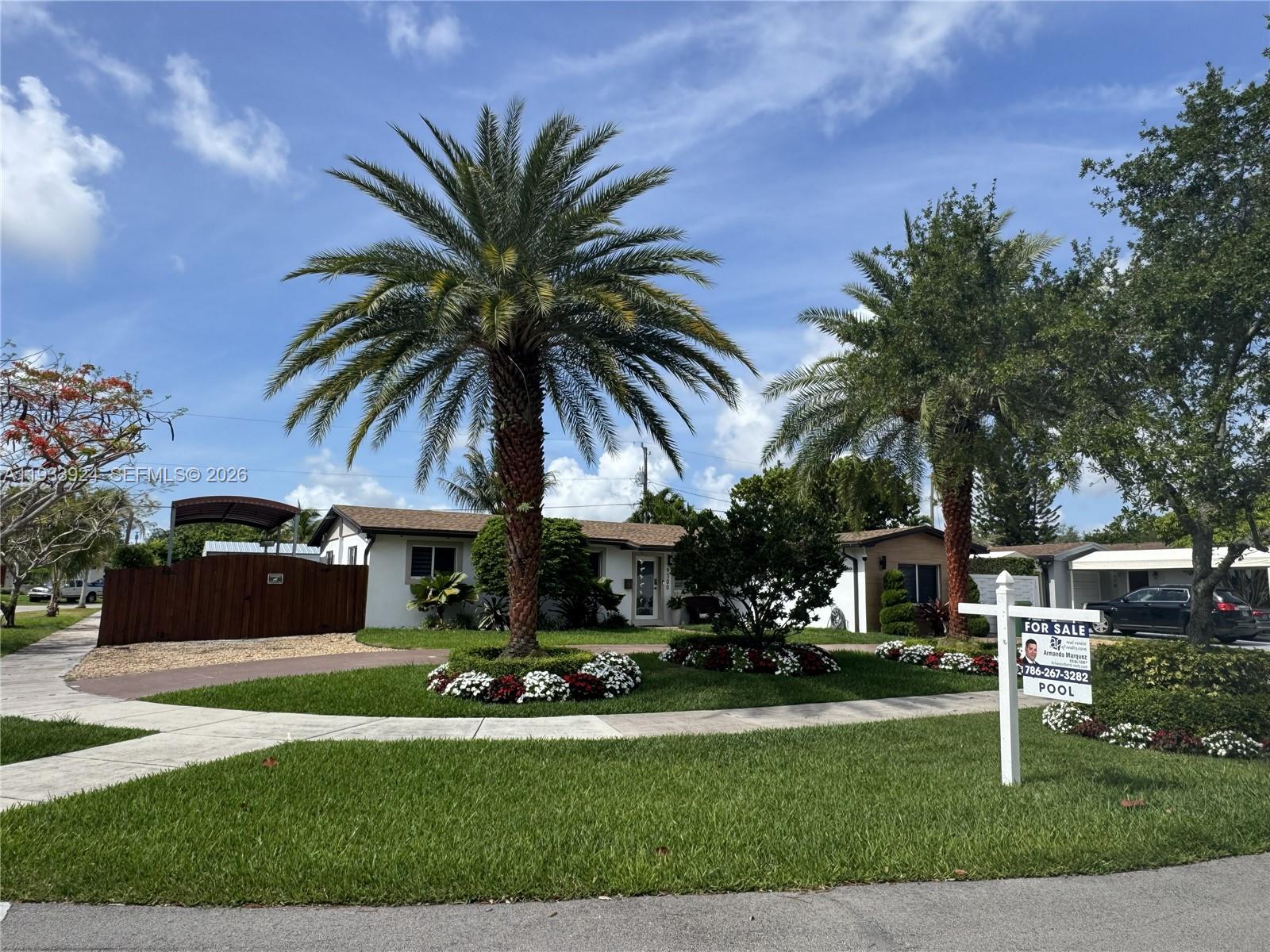A single-story house with palm trees, a front lawn, and a for-sale sign — 9300 SW 192nd Dr, Cutler Bay FL 33157, CUTLER BAY, FL