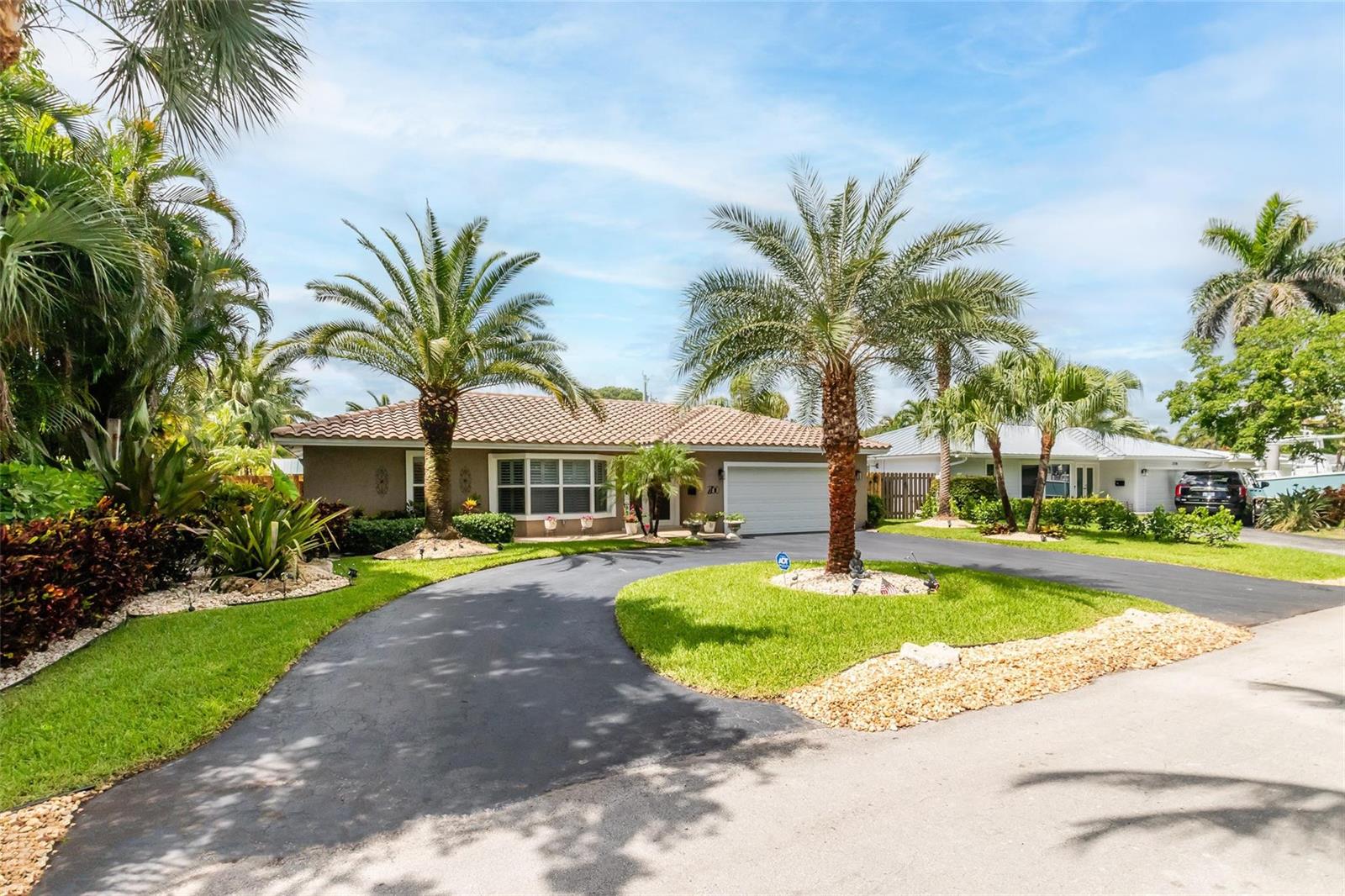 A single-story house with a tile roof, palm trees, and a curved asphalt driveway — 2750 SE 4th Street, Pompano Beach FL 33062, POMPANO BEACH, FL