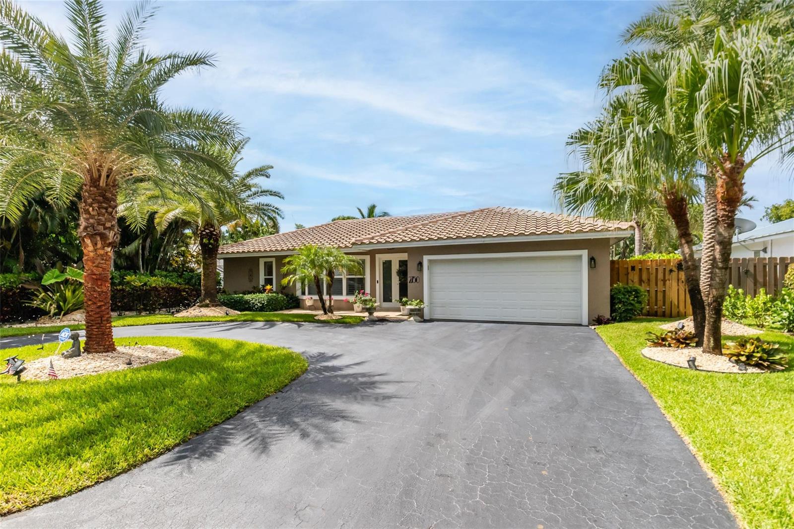 A single-story house with a tile roof, a two-car garage, and palm trees in front — 2750 SE 4th Street, Pompano Beach FL 33062, POMPANO BEACH, FL