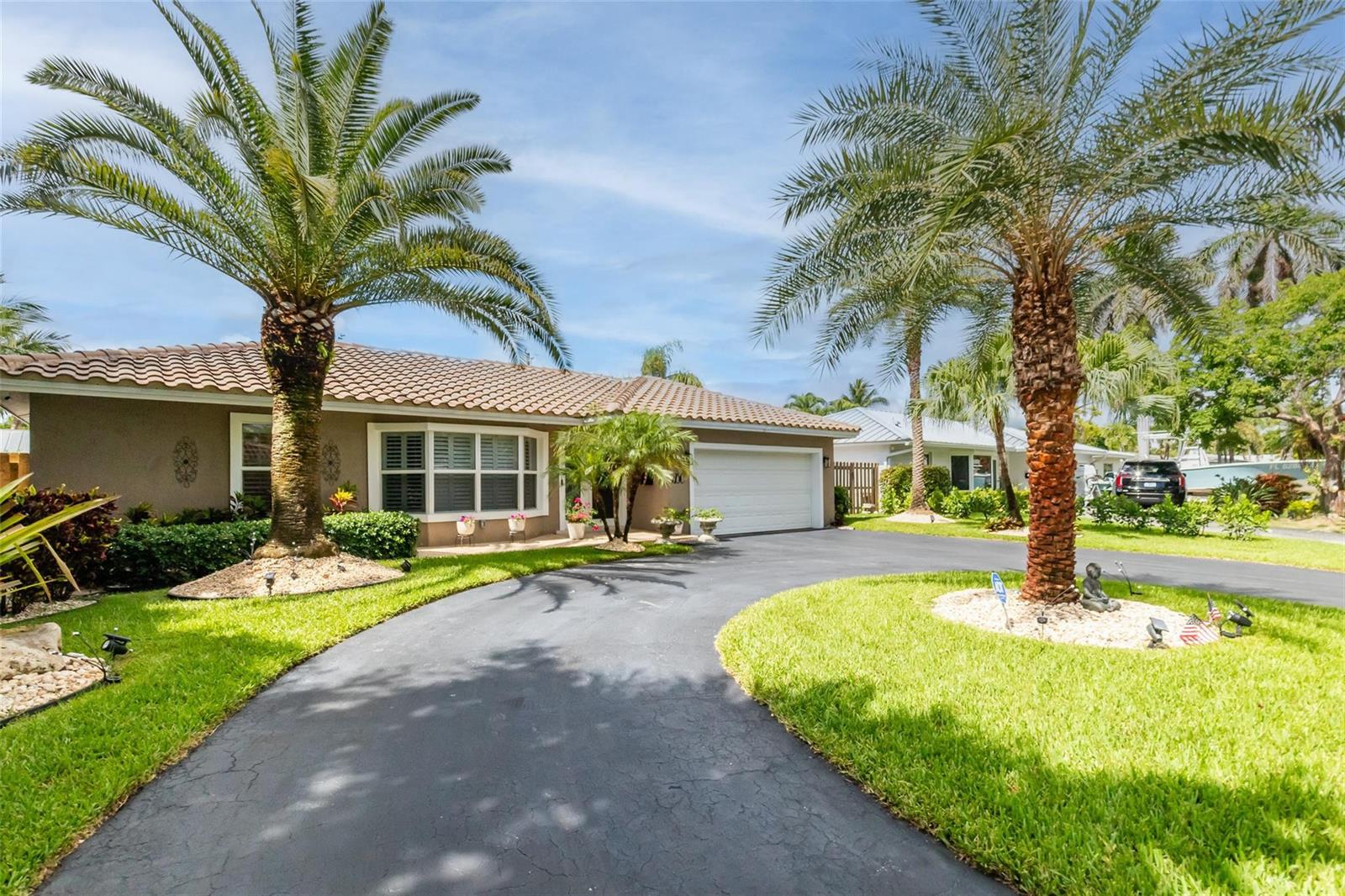 A single-story house with a tile roof, a circular driveway, and two prominent palm trees — 2750 SE 4th Street, Pompano Beach FL 33062, POMPANO BEACH, FL