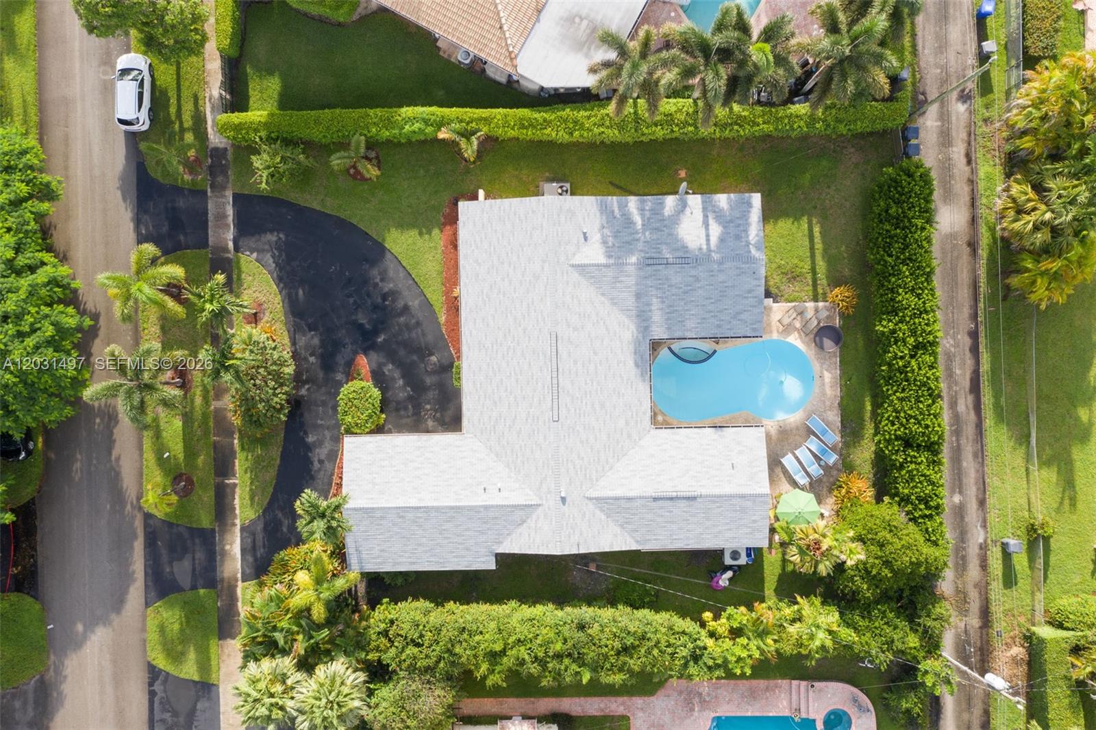 An aerial view shows a house with a grey roof, a pool, and a driveway — 4410 N Buchanan St, Hollywood FL 33021, HOLLYWOOD, FL