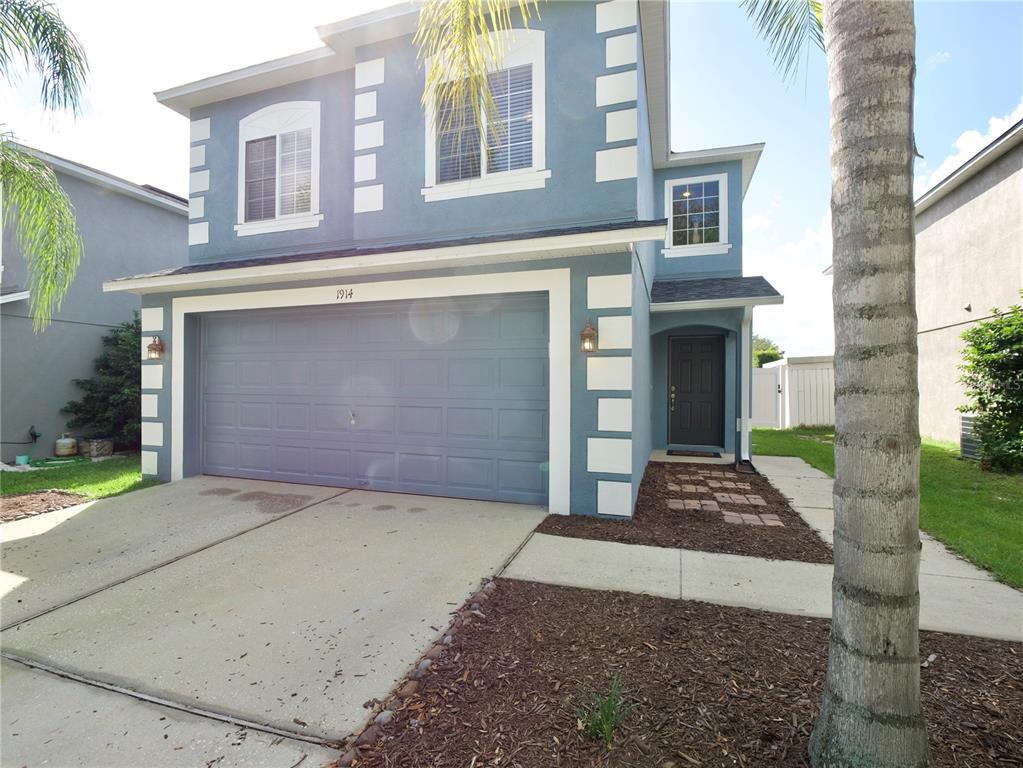 A two-story blue house with a two-car garage and a front walkway — 1914 SHERBOURNE STREET, WINTER GARDEN, FL