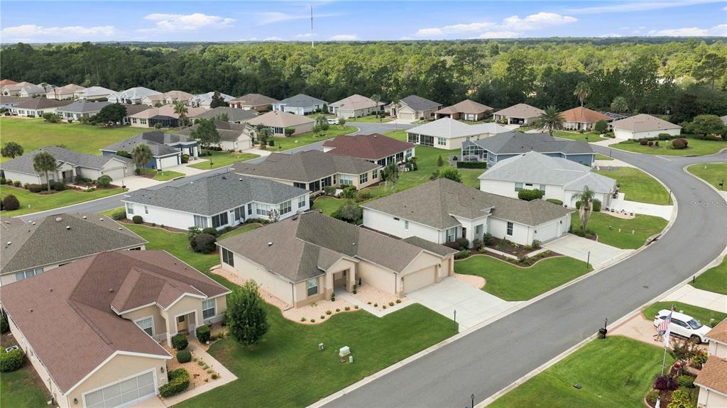 An aerial view of a suburban neighborhood featuring single-family homes with paved streets and lawns — 11811 SE 91ST CIRCLE, SUMMERFIELD, FL
